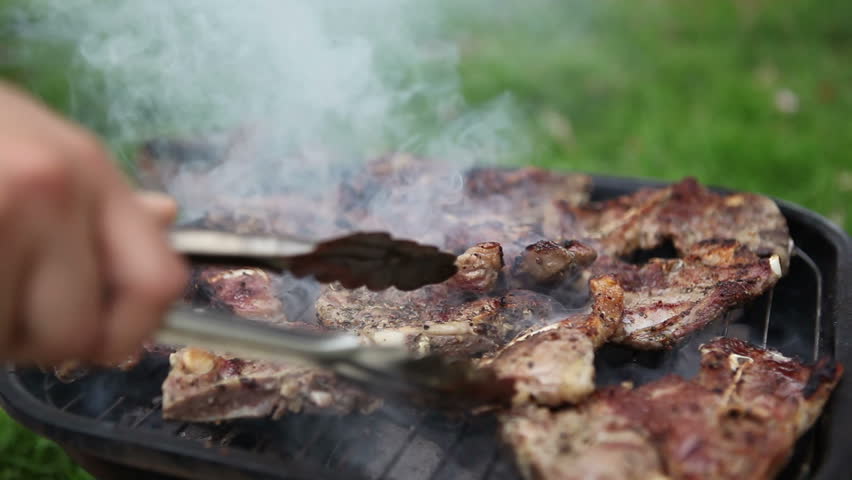 cooking lamb meat on outdoor barbecue