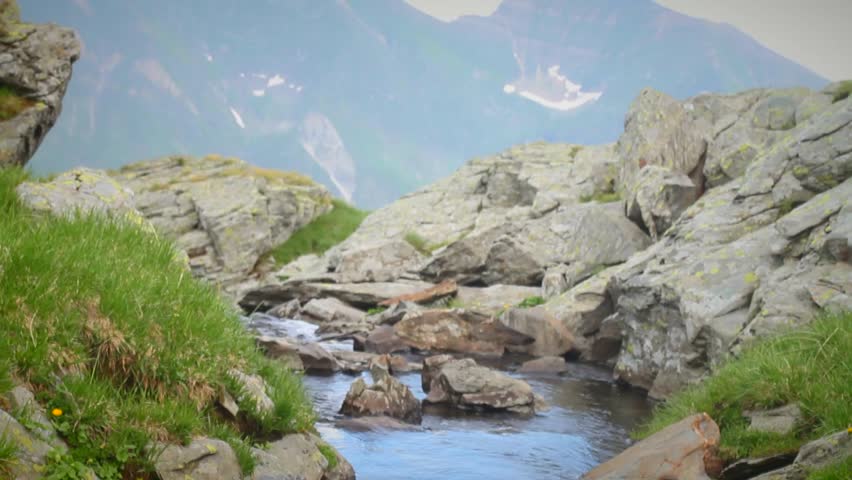 Mountain stream (watercourse) near Capra lake in Fogaras mountains, Transylvania, at 2300 meters altitude