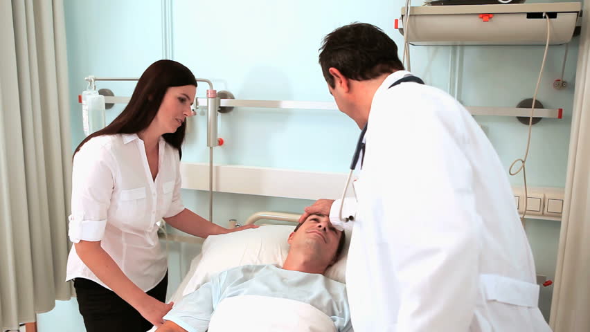 Video of a doctor examining a patient with a stethoscope in hospital ward