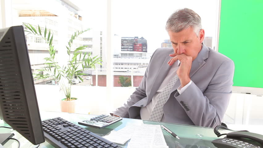 Annoyed businessman contemplating in an office