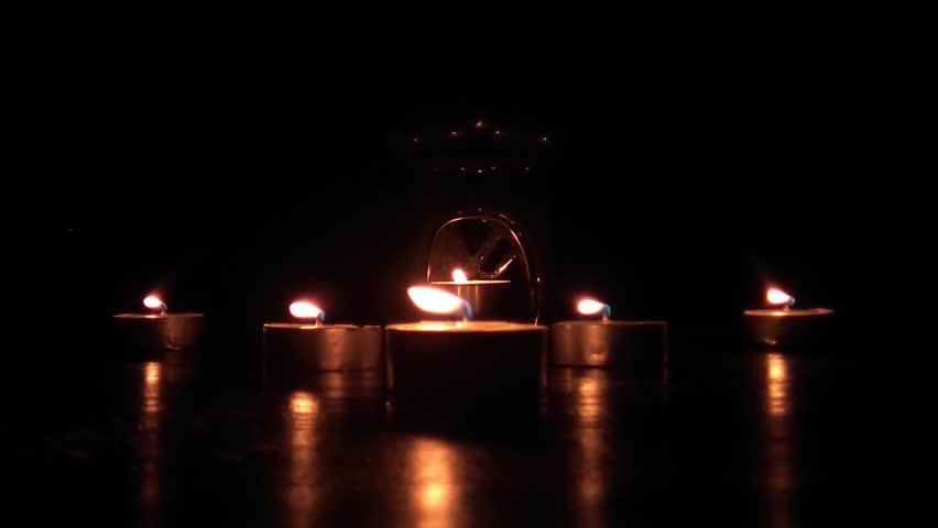 Beautiful candle lights in pitch black night 