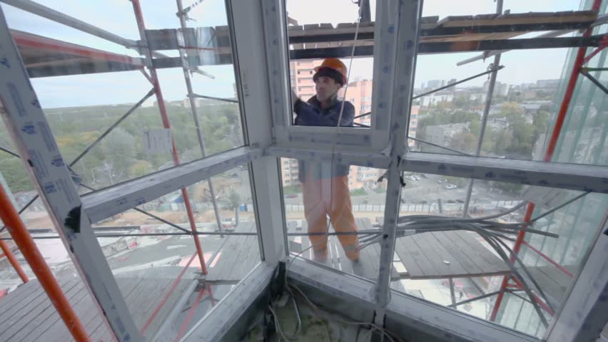MOSCOW - OCTOBER 7: Worker sets window in room of residential complex Elk Island on October 7, 2011 in Moscow, Russia. Complex includes 1334 apartments of 40-143 square meters