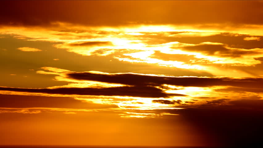 A timelapse of the setting sun as it flickers through passing cloud.