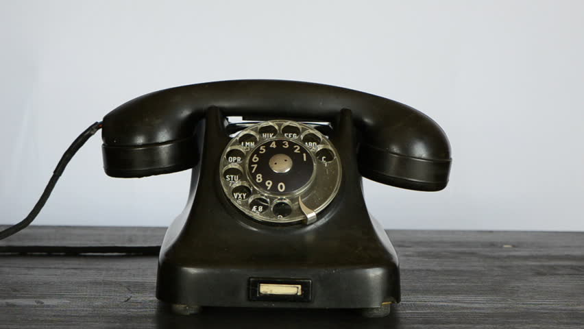 gangster hand with black glove calling antique telephone