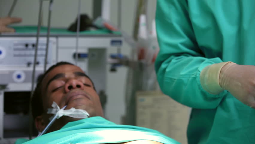 Surgeon holding a scissors during an operation in an operating