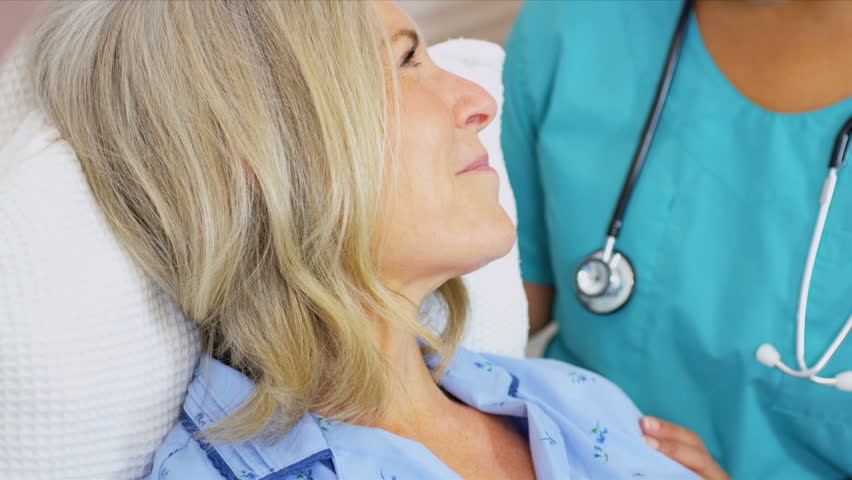 Hospital Staff Treating Senior Female Patient