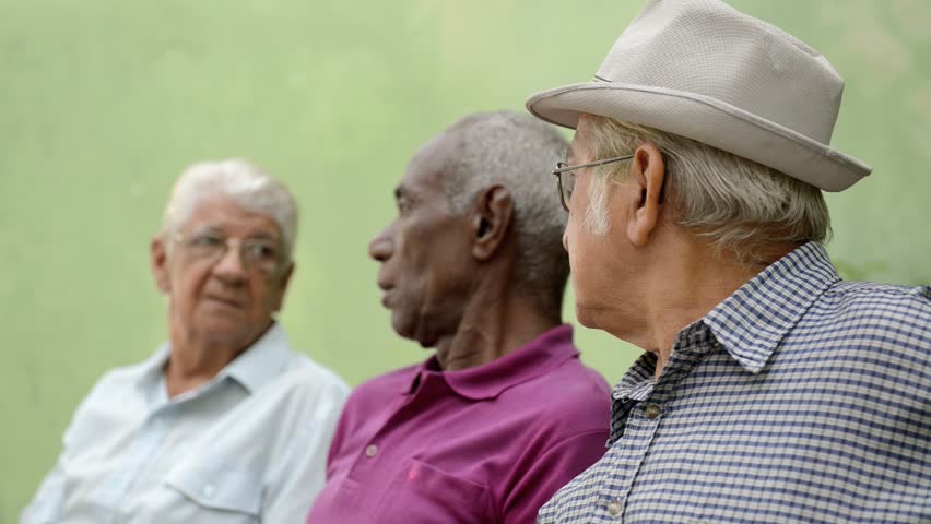 Active retirement and senior people, group of three old male friends talking and laughing on bench in public park. Sequence