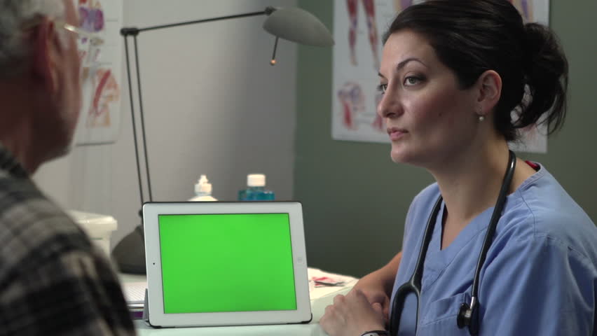 Doctor discussing results with patient on tablet, green screen