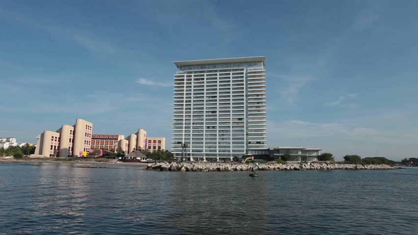 new luxury resorts and hotel draw international tourists back to the Riviera and beach destinations. pov from moving boat.