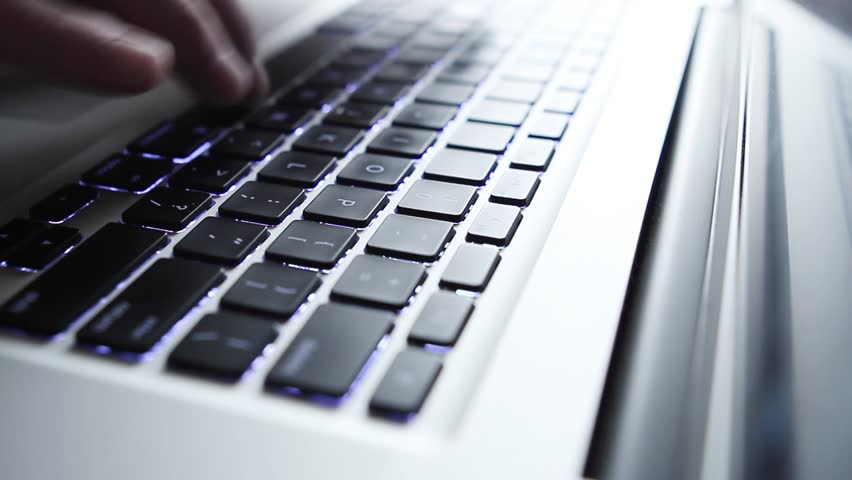 HD video of close up of fingers typing on computer keyboard