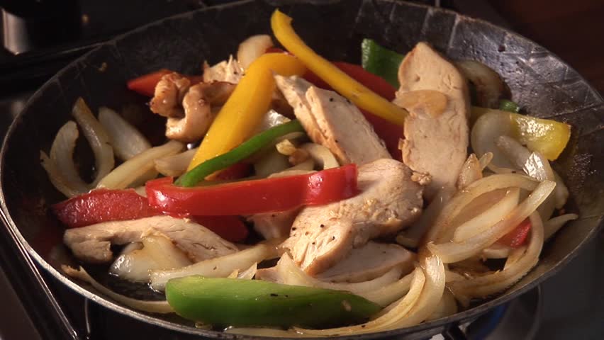 Cooking vegetables and chicken breast fillet in frying pan