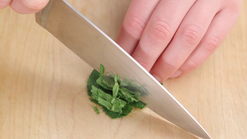 Mint leaves being finely sliced