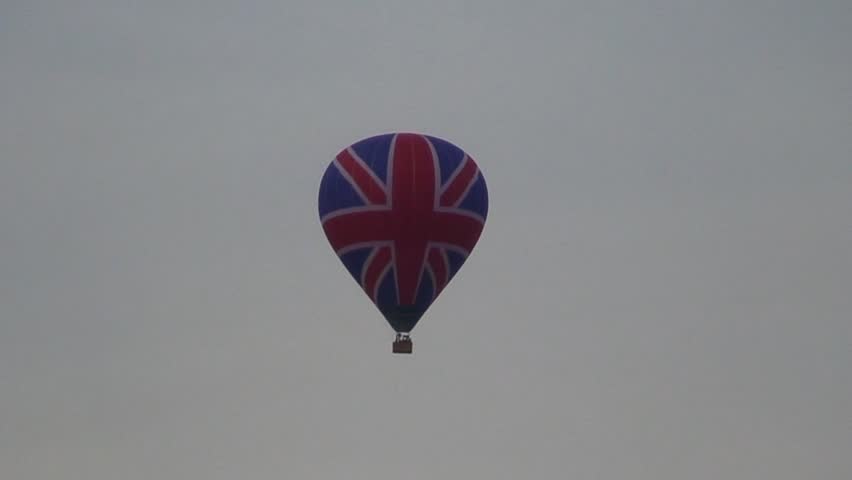 Hot air balloon in British Union Jack flag colours in flight over Bath in Somerset.