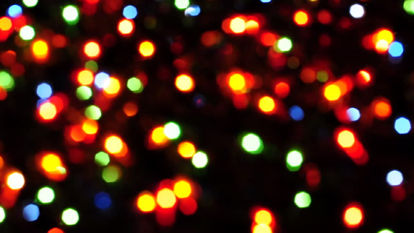 Blurred colorful Christmas lights on black background with varying fade and twinkle patterns