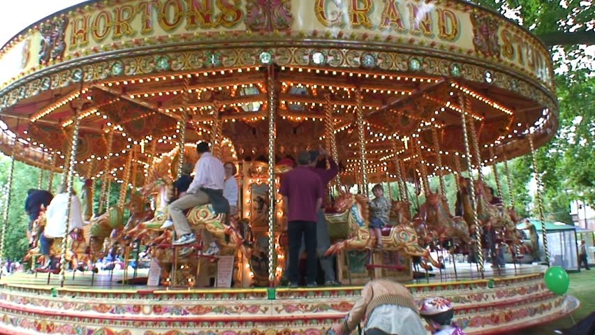 LONDON, ENGLAND - CIRCA 2011: A slowing down fairground merry-go-round attraction operating in South West London