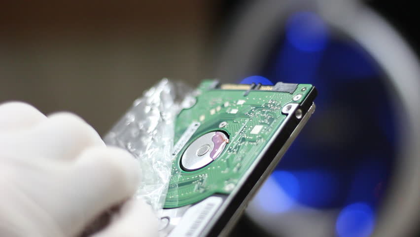 Technician wrapping hard drives for shipment    