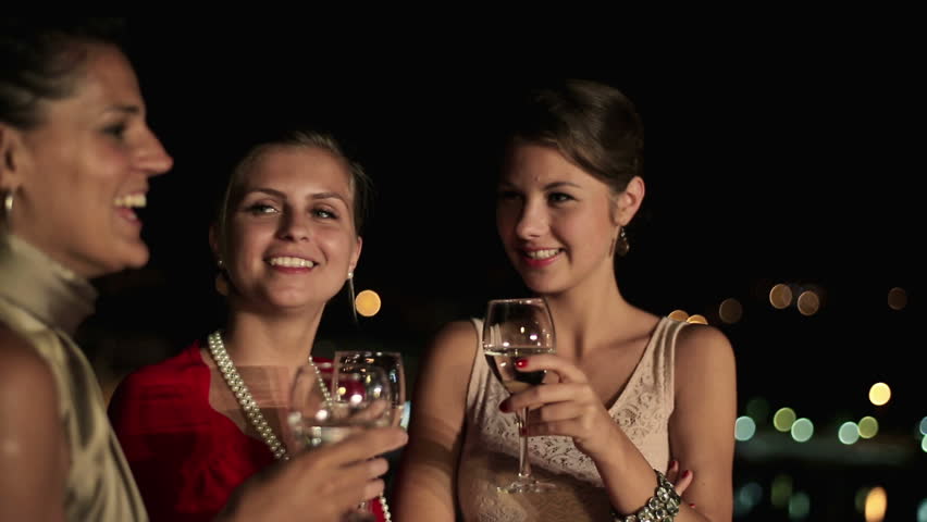 Happy girlfriends raising toast on party, steadicam shot
