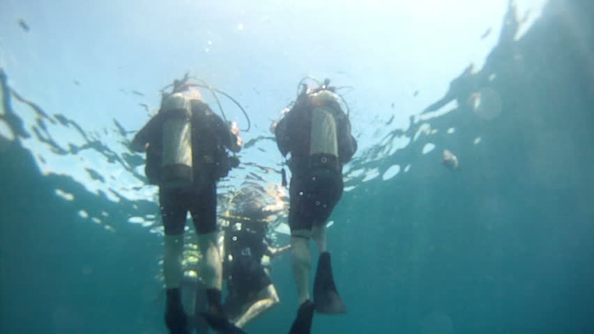 l increase to Mexican riviera resorts. Unidentified Scuba divers dive Pacific Ocean Mexico.