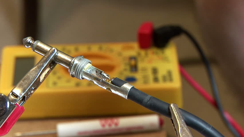 technician testing a connection using a multi meter