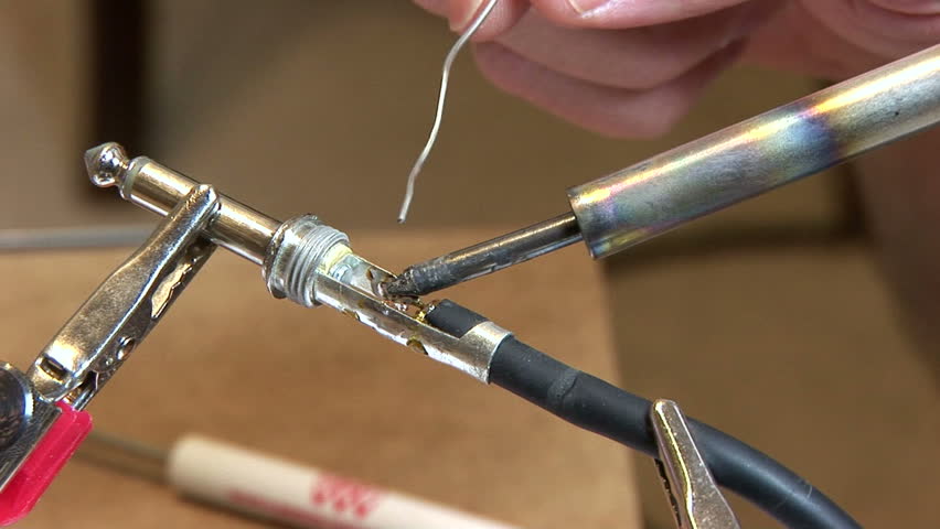 technician soldering an electrical connection