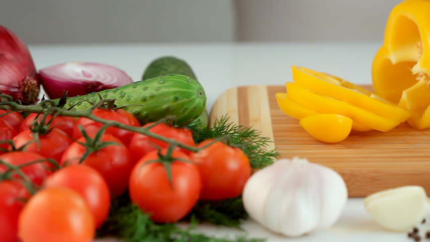 Female hands chopping yellow paprika (pepper)