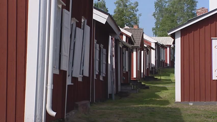 GAMMELSTAD LULEÃ, SWEDEN:  unpaved road between wooden huts church village. Gammelstad is an old parish with a long history.