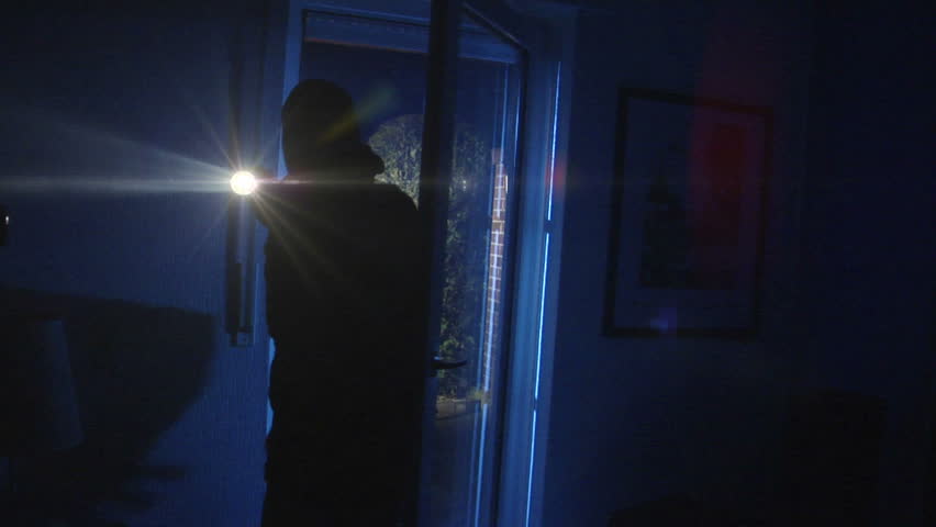 A burglar opens a porch door, comes in and watch around. 10840
