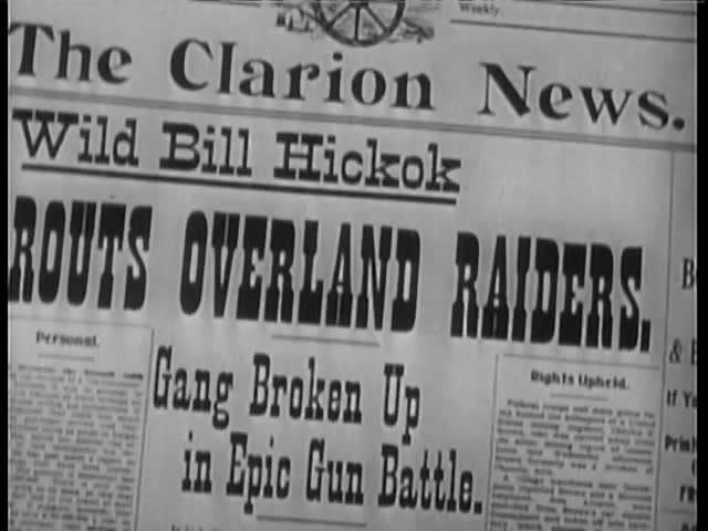 Close-up of newspaper headline Gang Broken Up in Epic Gun Battle