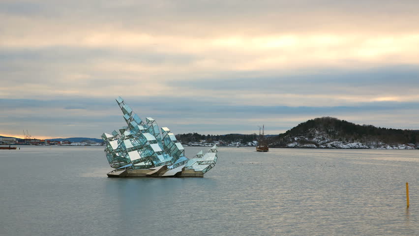 OSLO NORWAY JAN 2013: Art Sculpture - She Lies - is made of stainless steel and glass panels. Permanent installation floating on water. The sculpture turns on its axis in line with the tide and wind