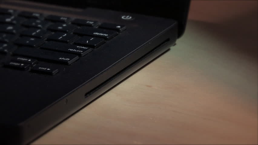 Ejecting a CD/DVD-ROM from a laptop.