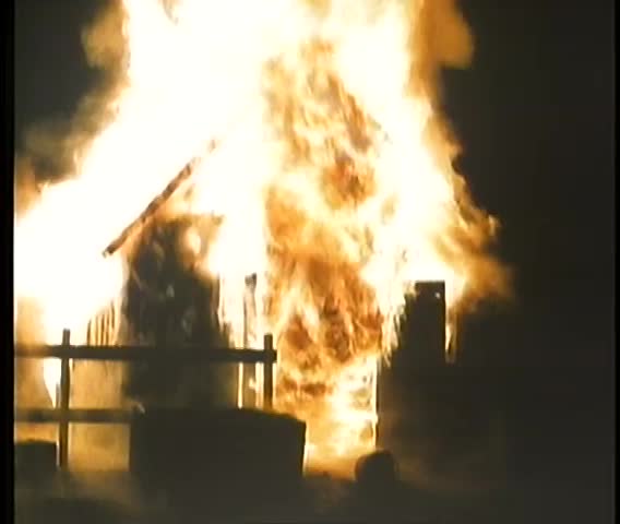 Farmhouse engulfed in flames at night