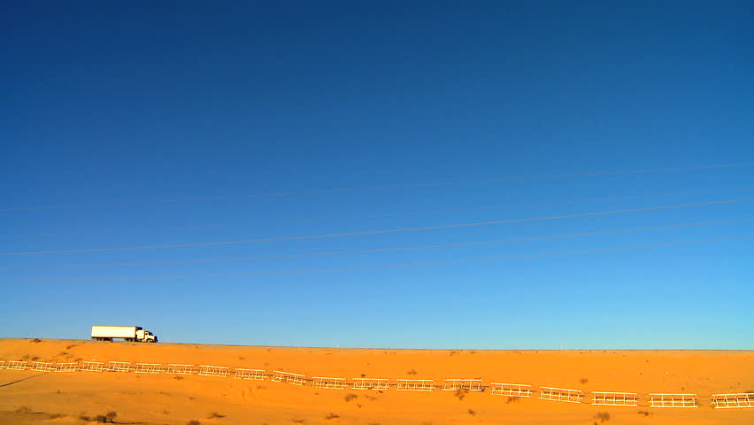 Trucks driving a desert highway