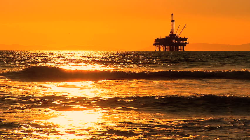 Oil platform in the sea at sunset