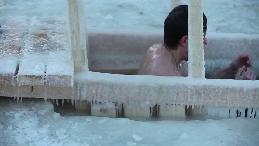 ST PETERSBURG - JAN 19: Winter swimmer in ice water on January 19, 2013 temperature of -14 degrees, the river Neva, St. Petersburg Russia