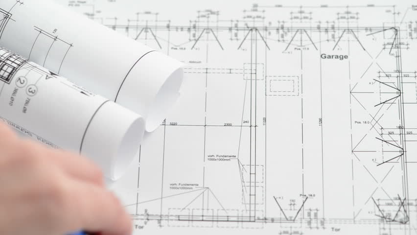 A pen rolls over  an architectural drawing blueprint. Two sequences in one video.