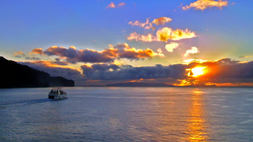 High definition time lapse of a ship sailing into the sunrise.
