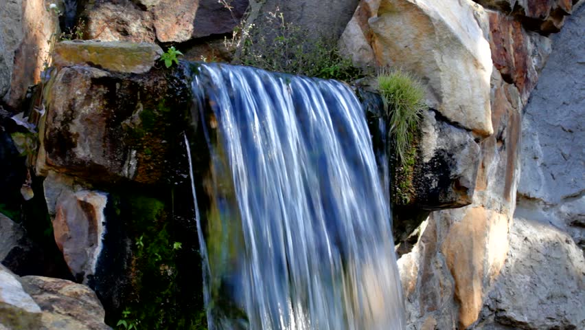 small waterfall tumbles down a cliff