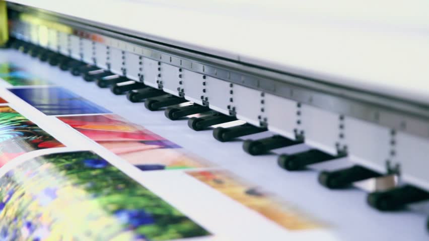 Printing head creates colorful image on paper in machine