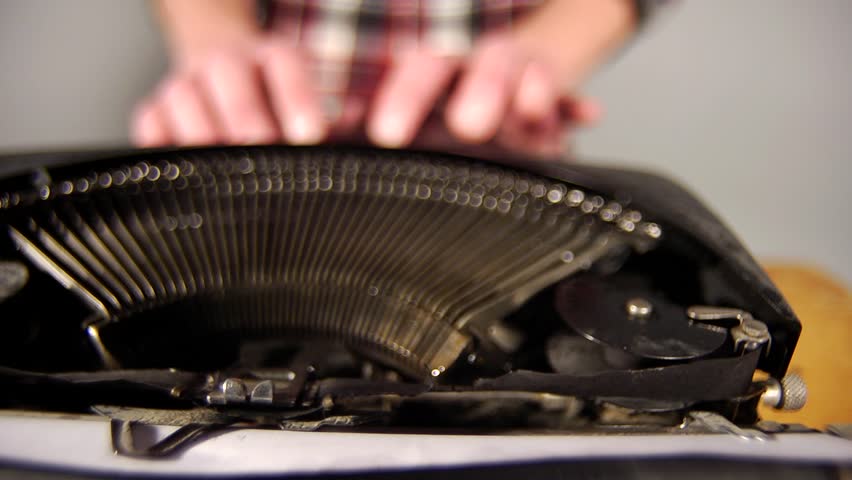Typing on Typewriter
A man types on a typewriter. The keys are in focus and the man is out of focus. 