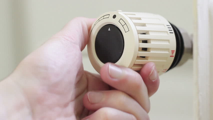 Radiator thermostat, selective focus, white background, turned up to maximum