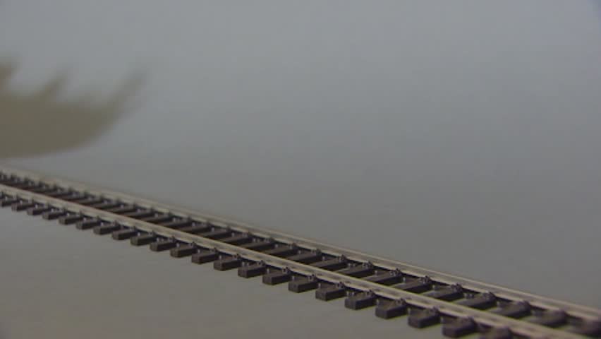 model train runs forward towards camera stops and runs backwards - medium shot