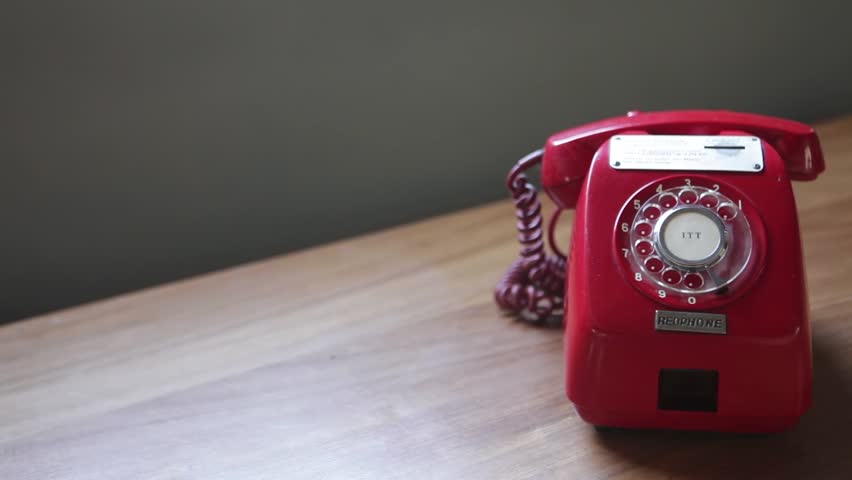 dolly shot of old vintage rotary coin red phone