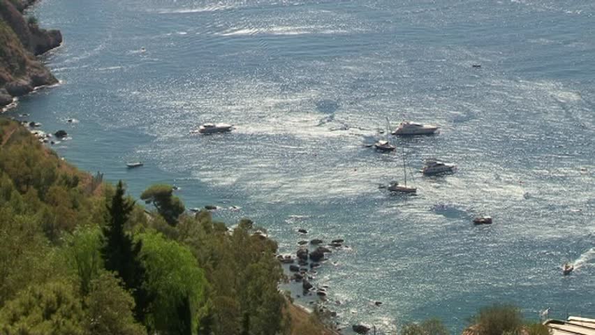 Italy, Sicily, Castelmola (Taormina), view of the sicilian eastern rocky coastline and Ionian sea, Calabria coast in the far back