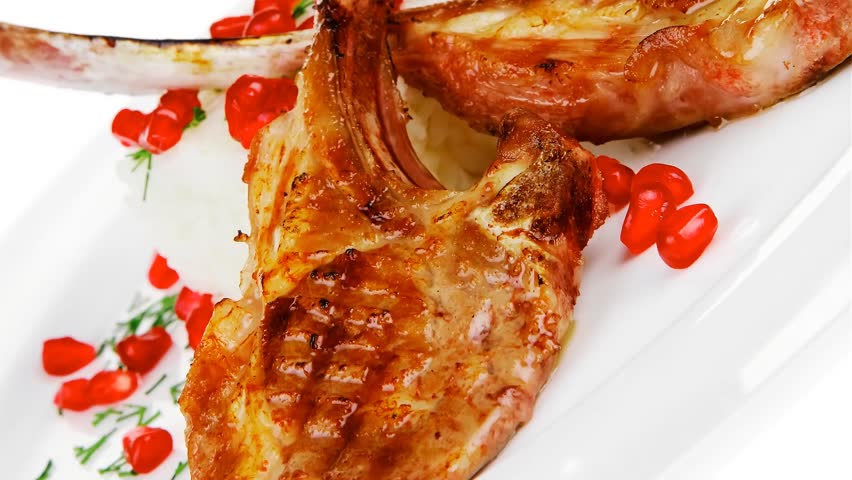 main course: grilled ribs with rice and tomatoes on white plate hidef slow motion intro