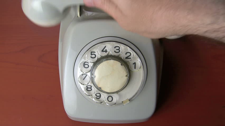 dialing a number on a vintage rotary dial telephone