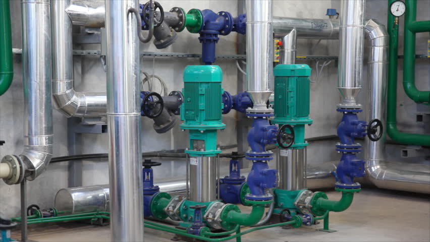 Man working in a factory, controls the operation of devices in a Heating Plant