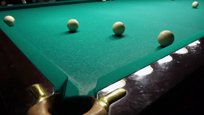 Playing pool, hitting the ball closeup view