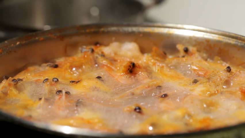 Shrimp are simmered in a saucepan.