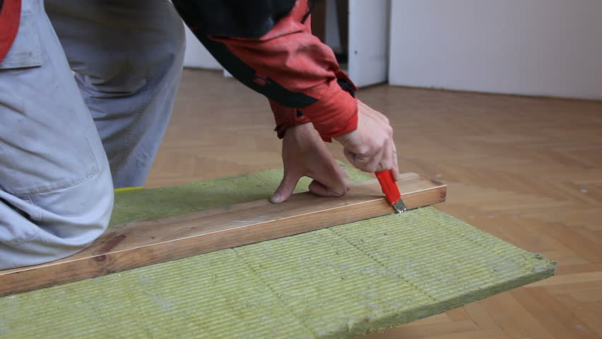 Man cutting fiberglass insulation