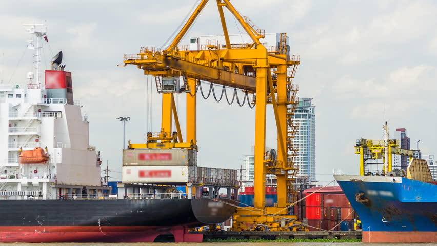 Container Cargo freight ship with working crane bridge in shipyard for Logistic Import Export background 